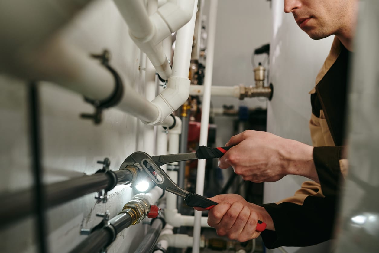 Plumbers maintaining commercial plumbing pipes in Largo