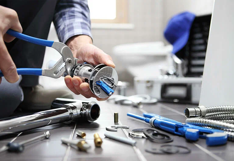 Technician repairing a plumbing fixture with professional tools in Largo