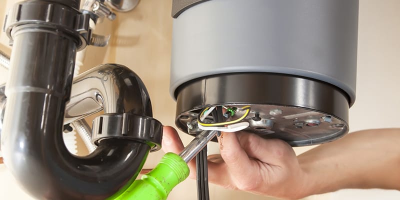 Technician repairing the heating element of a water heater in Largo