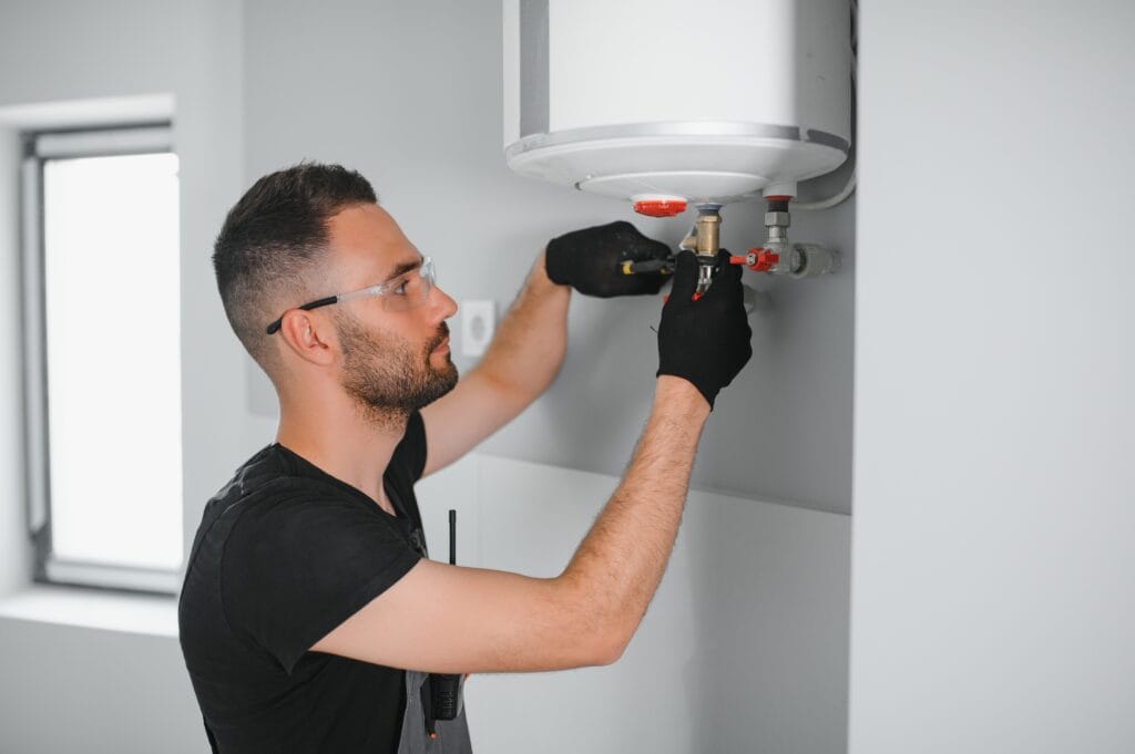Technician performing water heater maintenance in Largo