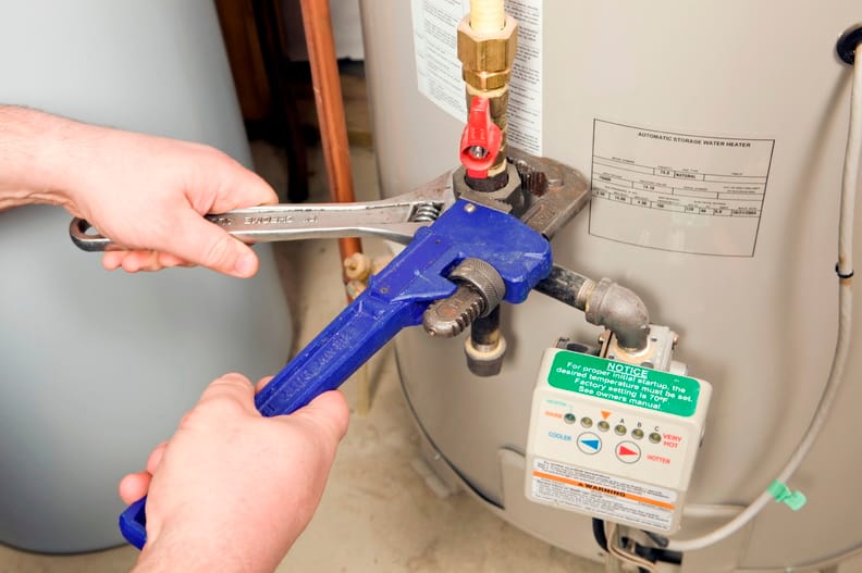 Plumber repairing a water heater valve in Largo